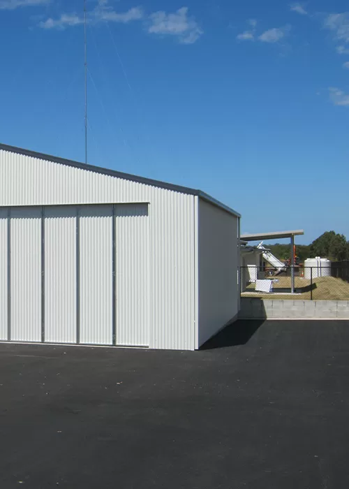white shed with folding doors