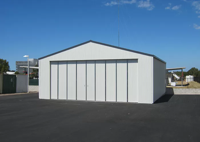 large white shed with folding doors