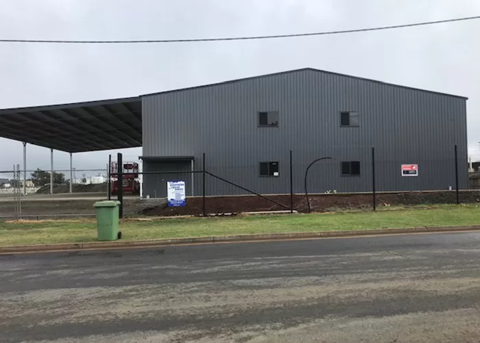 large dark grey industrial shed side